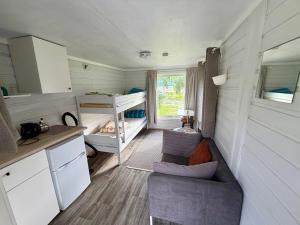 a tiny house with a kitchen and a bunk bed at Mørsvikbotn Camping AS in Mørsvik