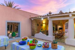 a house with a table with food on a patio at Passione Mare in Porto Palo