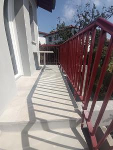a red railing on a porch of a house at Appartement Neuf avec Balcon in Hendaye