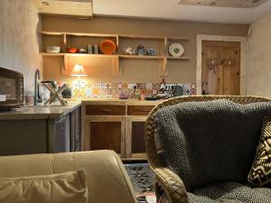 a kitchen with a couch and a chair in a room at Adorable Yurt Glamping Bantry in Bantry