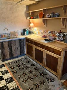 a kitchen with wooden cabinets and a tile floor at Adorable Yurt Glamping Bantry in Bantry +17 photos