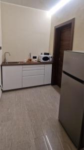 a kitchen with a refrigerator and a microwave at Damhomeitaly in Modena
