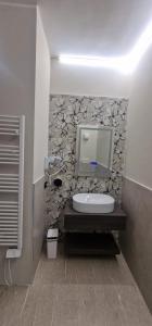 a bathroom with a sink and a tv on a wall at Damhomeitaly in Modena
