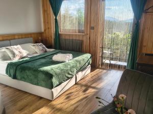 a bedroom with a bed and a large window at Sądelska Chałpa in Murzasichle