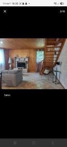 a living room with a couch and a fireplace at Isa's Little Cottage in Saint-Bonnet-de-Chirac +11 photos