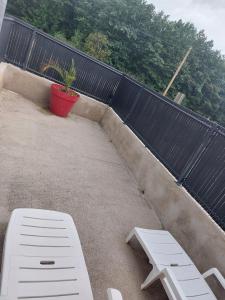 a white bench and a potted plant on a patio at Pavillon - T2 Duplex avec Terrasse et Parking in Montagnat