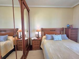 a bedroom with two beds and a large mirror at Apartamento Ora al Mare - 32002 in Pedreña