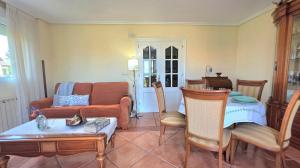 a living room with a couch and a table at Apartamento Ora al Mare - 32002 in Pedreña +9 photos