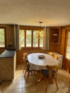 a kitchen with a table and chairs in a room at Chalet Royal in Les Diablerets