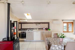 a kitchen with a table and a kitchen with a stove at The Lake View - Terrazza Panoramica Vista Lago in Marta