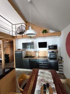 a kitchen with a wooden table in a room at Ferienhaus Seeblick in Rheinsberg