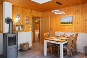 a kitchen and dining room with a table and a stove at Ortheide 68 in Böddenstedt
