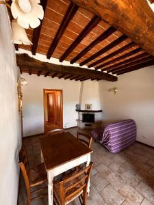 a dining room with a wooden table and chairs at La Sosta Nel Chianti in Castelnuovo Berardenga