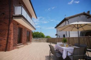 a patio with a table and an umbrella at La Villa de Miera - 12809 in Ajo
