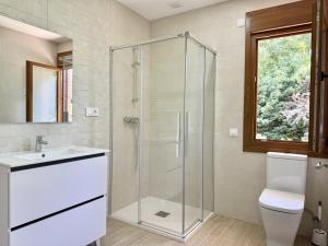 a bathroom with a shower and a toilet and a sink at La Villa de Miera - 12809 in Ajo +6 photos