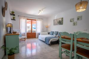 a bedroom with a bed and a desk in it at Apartamentos Obelisc in Can Picafort +106 photos