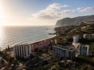 an aerial view of a city and the ocean at SociaLodge - Piornais in Funchal
