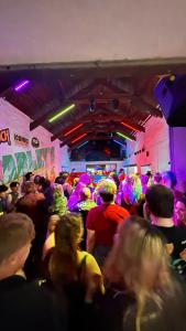 a crowd of people sitting in a room at a party at Harley's in Aberystwyth