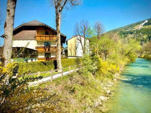 a house on a hill next to a river at Riverhaus in Schladming