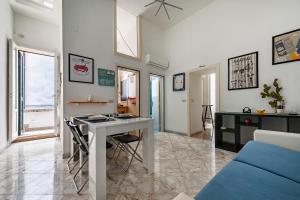 a living room with a table and a desk at 15min Polignano Puglia Historical Center Terrace in Conversano