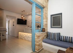 a living room with a couch and a sink at Ioanna Apartments in Agios Prokopios