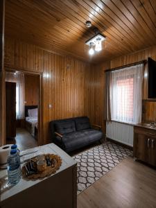 a living room with a couch and a table at Han PANSİYON in Çaykara