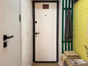 a white door in a room with a yellow wall at New stail centru in Bălţi