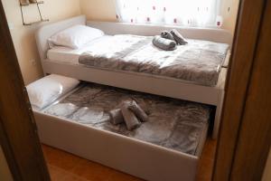 two beds in a room with two teddy bears on them at Villa Trigona in Kalabaka