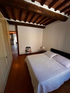 a bedroom with a bed and a chair in it at La Sosta Nel Chianti in Castelnuovo Berardenga