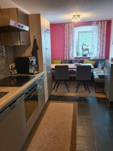 a kitchen and living room with a table and chairs at Ferienhaus Strohmayer in Schweiggers