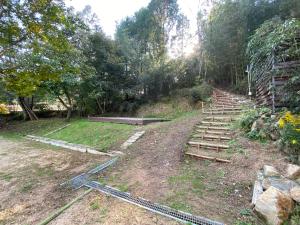 a set of stairs on a hill with trees at うさぎのキャンプ広場 in Oguni