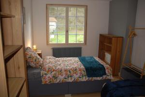 a bedroom with a bed and a window at Etape motards chez Fred et Flo in Compreignac +28 photos
