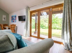a living room with a sliding glass door at Henlle Home Farm in Oswestry