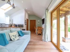 a living room with a couch and a kitchen at Henlle Home Farm in Oswestry +26 photos