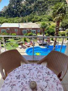 a table and chairs with a view of a pool at Villa INA in Kaluđerac