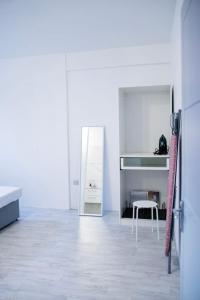a white room with a mirror and a table at Beach Bay Terrace with Mountain views in Buccament