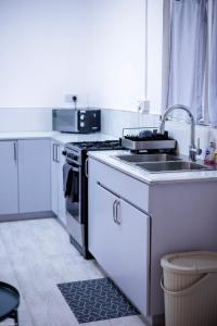 a kitchen with a sink and a stove at Beach Bay Terrace with Mountain views in Buccament +12 photos