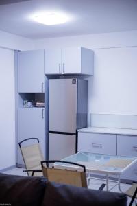 a kitchen with a glass table and a refrigerator at Beach Bay Terrace with Mountain views in Buccament