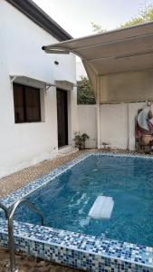 a swimming pool in front of a house at Al Rabi Rest House in Khor Fakkan +4 photos