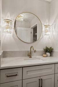 a bathroom with a sink and a mirror at The Luxury Haus in Grove City