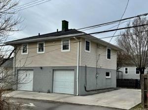 a house with two garage doors at The Luxury Haus in Grove City