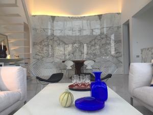 a blue vase on a table in a living room at Villa Mirano in Éze
