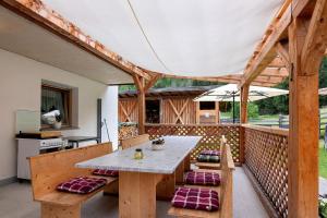 eine Außenterrasse mit Tisch und Bänken in der Unterkunft Pirchahof in Martell