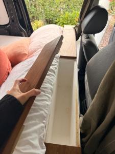 a person is packing a bed in the back of a van at Caddy Car in Brisbane +5 photos