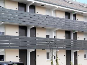 a building with a gray walkway on the side of it at greet Hotel Chatellerault in Châtellerault