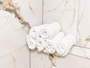 a pile of towels on a wall in a bathroom at Teslić CITY Apartment in Teslić +13 photos