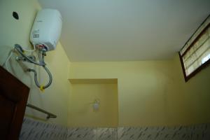 a shower in the corner of a room at SV Grand in Kākināda
