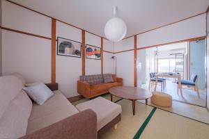 a living room with a couch and a table at Castle Land NAGOYA Family Friendly 5min from Station in Nagoya