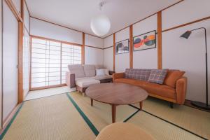 a living room with a couch and a table at Castle Land NAGOYA Family Friendly 5min from Station in Nagoya