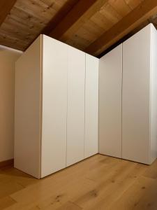 an empty room with white walls and wooden ceilings at Il Rifugio di Palmanova in Palmanova